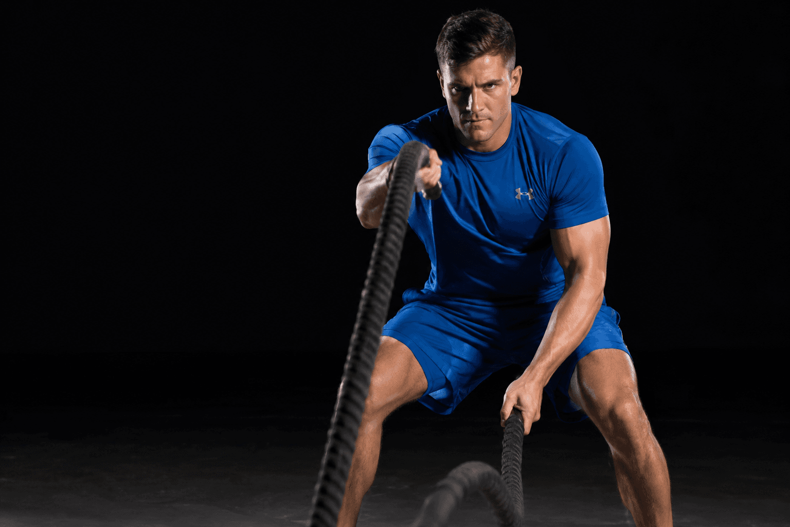 Athlete training with battle ropes